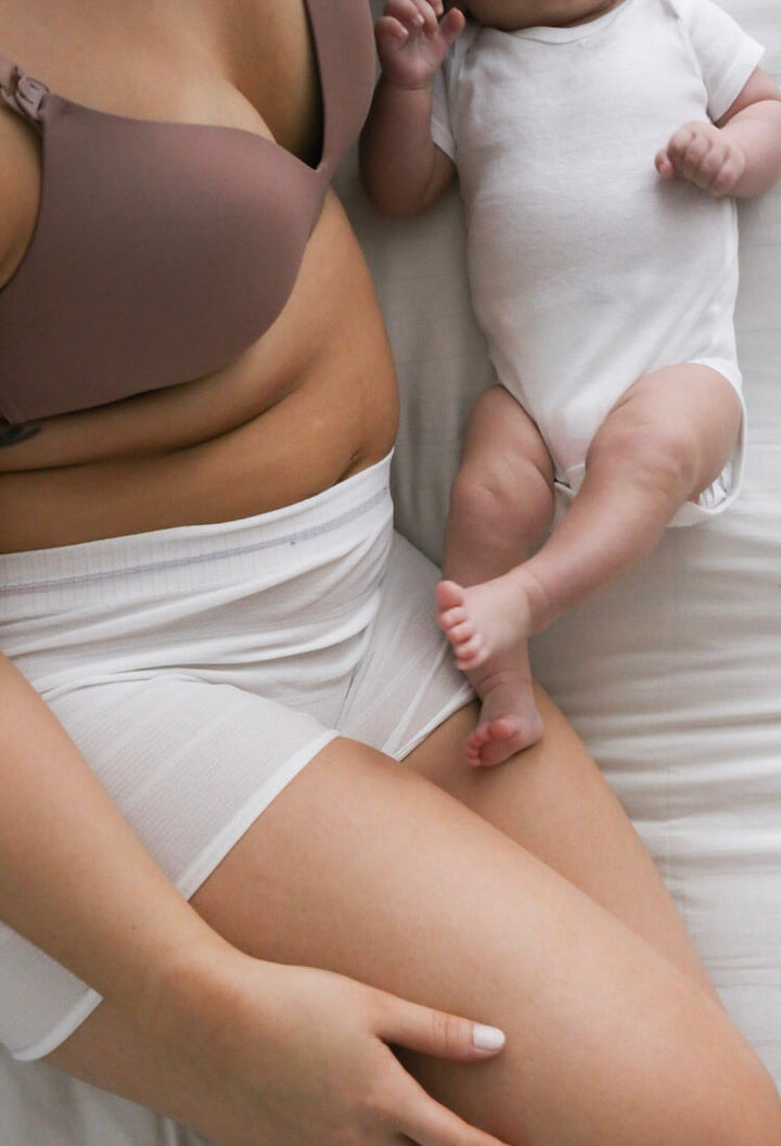 Mother wearing mesh underwear with baby